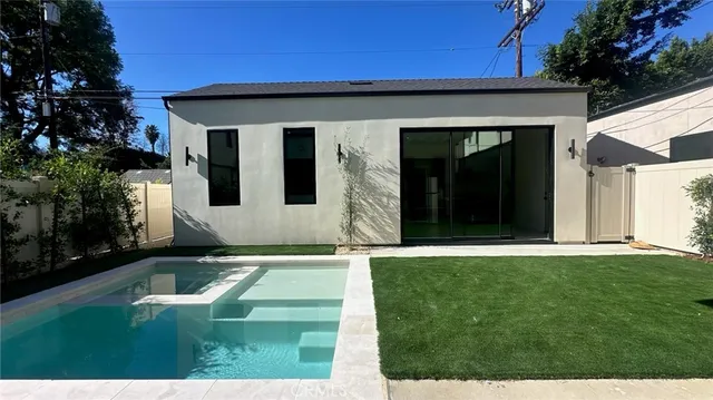 a view of an house with backyard space and garden
