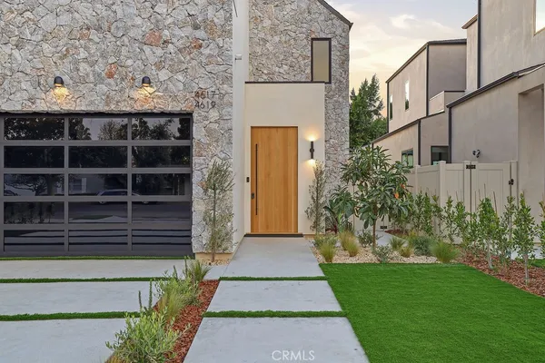 a front view of a house with a garden