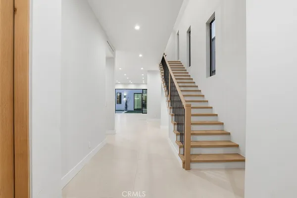 a view of entryway and hall with wooden floor