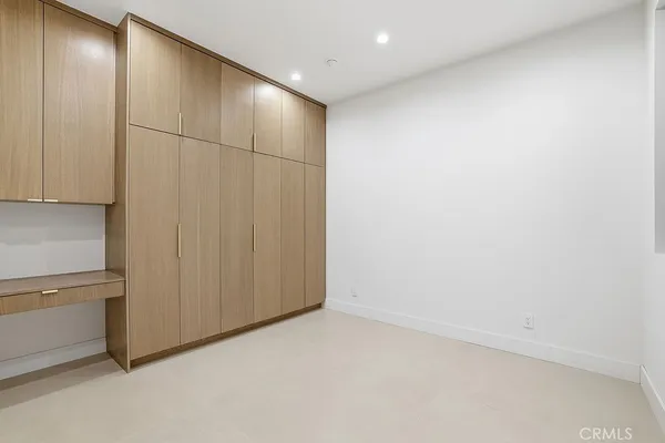 a view of a kitchen with a sink and refrigerator