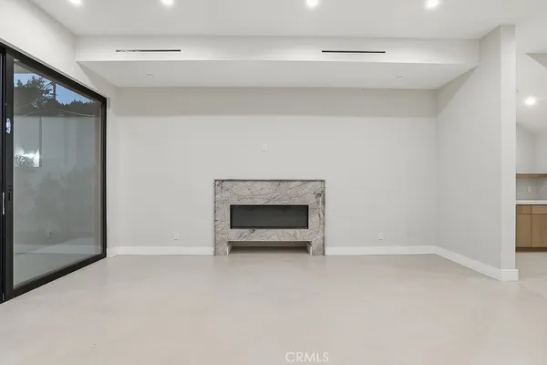 a large kitchen with kitchen island a large counter top space a sink stainless steel appliances and cabinets