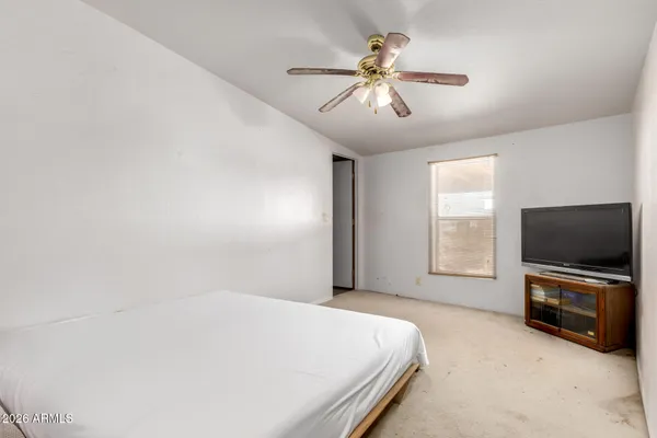a bedroom with a bed and a chandelier