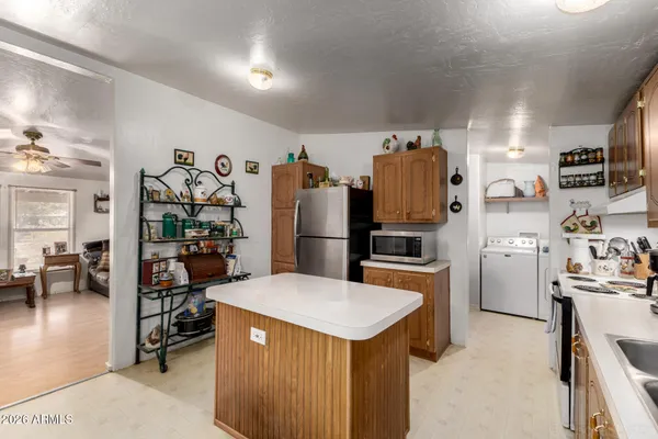 a kitchen with refrigerator and stove