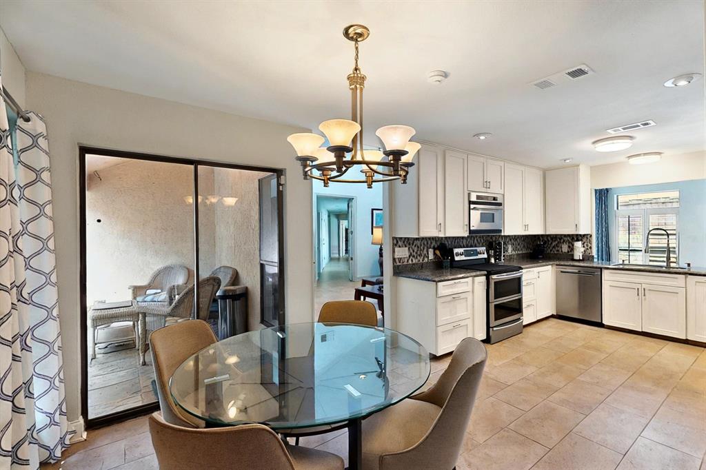 7109 Alpha Road Dallas, TX 75240 - Photo 11 of 36 a kitchen with cabinets a sink and appliances