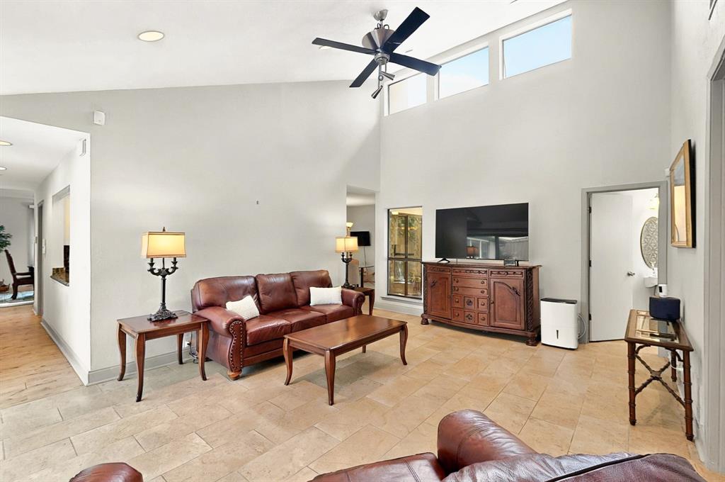 7109 Alpha Road Dallas, TX 75240 - Photo 16 of 36 a living room with furniture and a flat screen tv