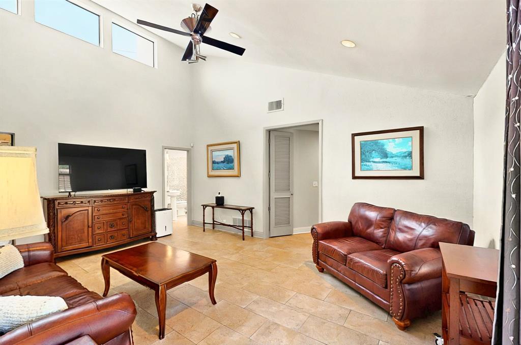 7109 Alpha Road Dallas, TX 75240 - Photo 17 of 36 a living room with furniture and a flat screen tv
