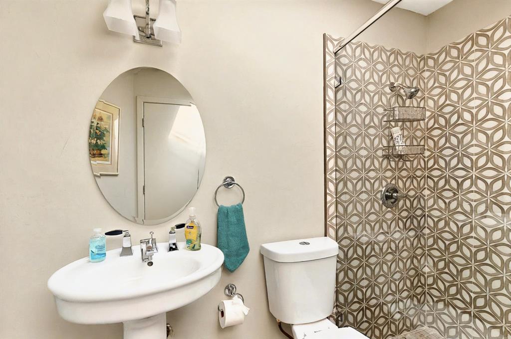 7109 Alpha Road Dallas, TX 75240 - Photo 18 of 36 a bathroom with a sink toilet and mirror