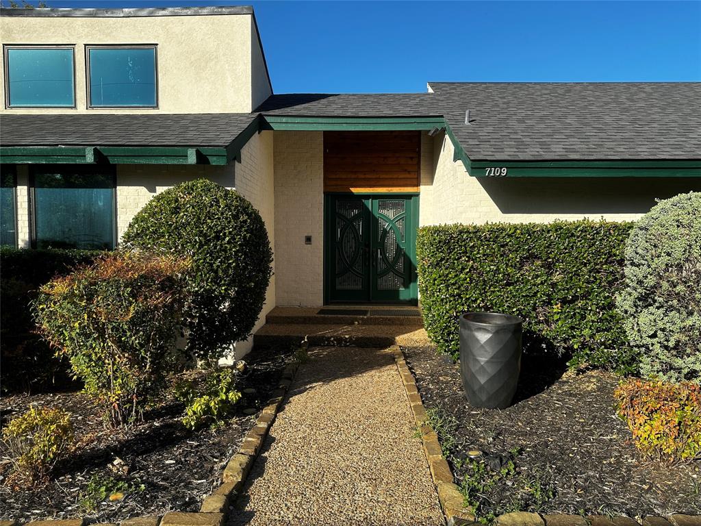 7109 Alpha Road Dallas, TX 75240 - Photo 2 of 36 a front view of a house with a yard