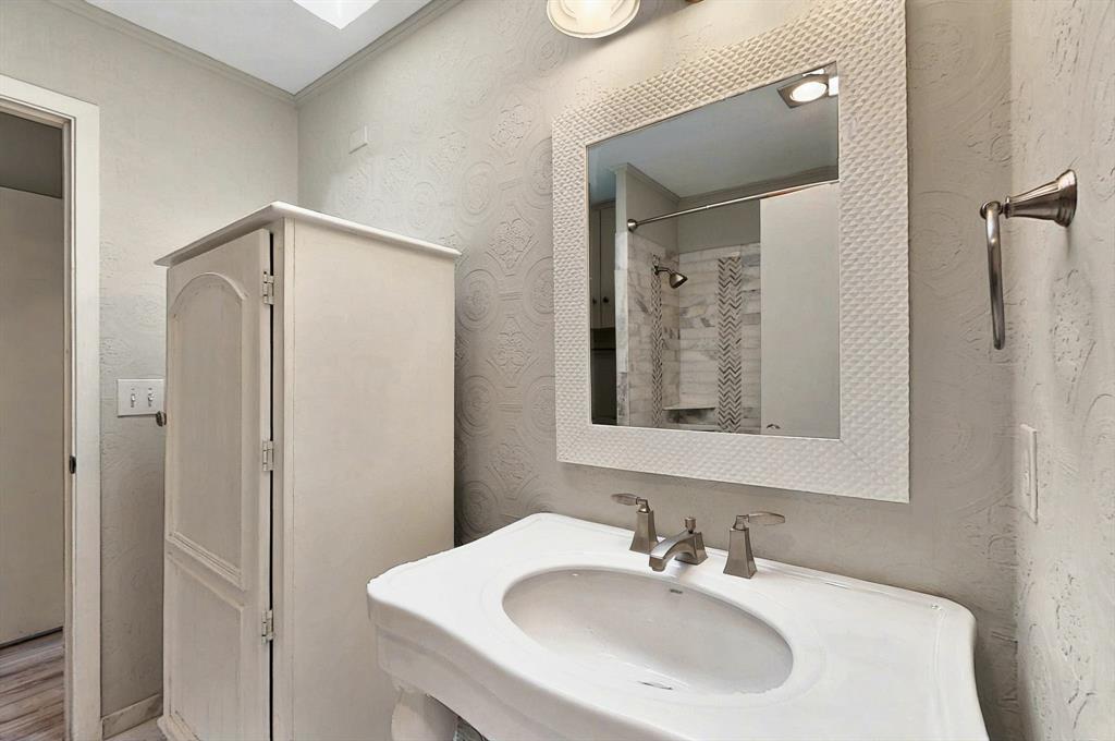 7109 Alpha Road Dallas, TX 75240 - Photo 22 of 36 a bathroom with a sink and mirror