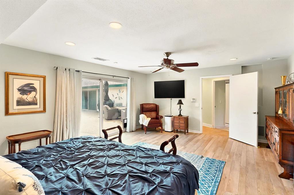 7109 Alpha Road Dallas, TX 75240 - Photo 25 of 36 a bedroom with a bed and a flat screen tv