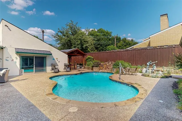 a view of a swimming pool with a patio