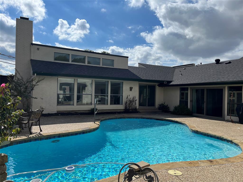 7109 Alpha Road Dallas, TX 75240 - Photo 31 of 36 a view of a house with a swimming pool and a yard