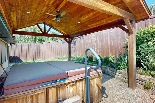 a view of a patio with table and chairs with wooden fence