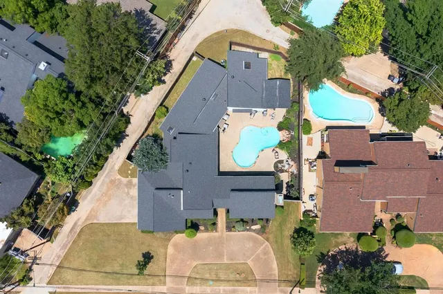 an aerial view of multiple houses with a yard