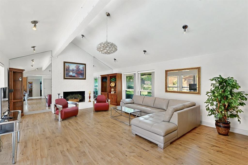 7109 Alpha Road Dallas, TX 75240 - Photo 4 of 36 a living room with furniture flower pot and a fireplace