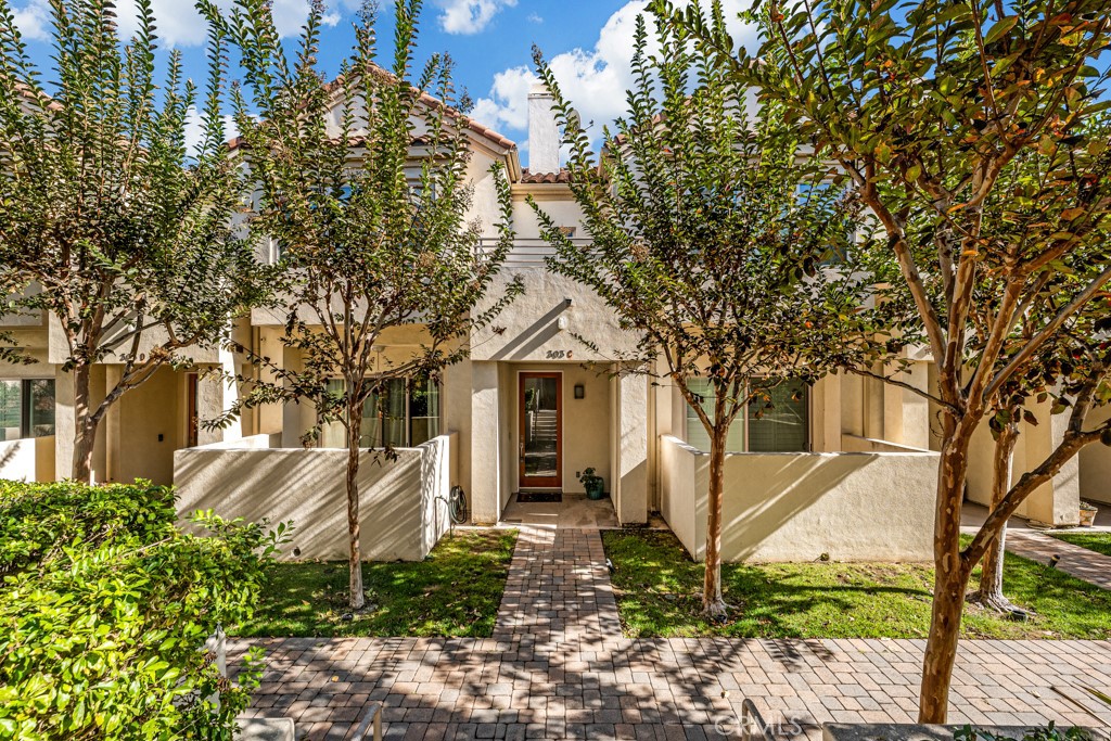 303 Kansas Street, Unit C El Segundo, CA 90245 - Photo 1 of 1 a white house that has a tree in front of it