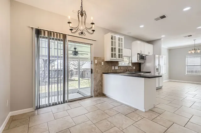 a kitchen with stainless steel appliances granite countertop a refrigerator and a stove top oven