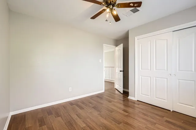 a view of a room with wooden floor and white walls