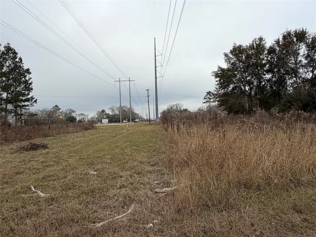 a view of a field with trees in the background