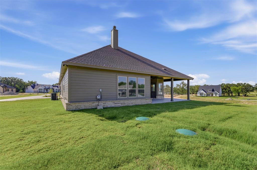 605 Tay Tay Way Springtown, TX 76082 - Photo 27 of 31 Single-story residence featuring composite shingle roofing, horizontal siding, and a stone foundation