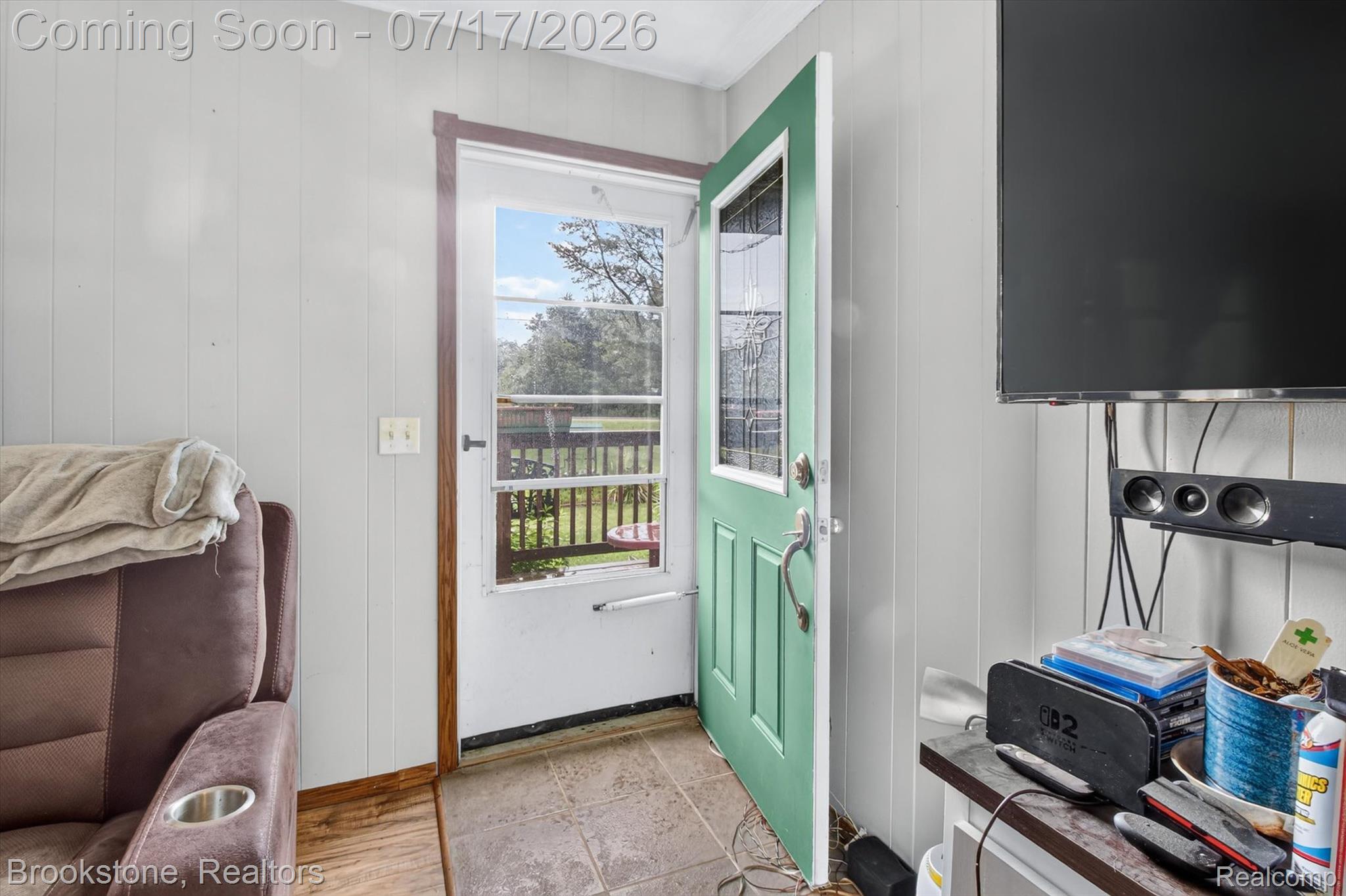 22709 Pleasant Valley Road Hillman, MI 49746 - Photo 9 of 42 Entryway featuring a light green door with decorative glass inserts, leading to an exterior deck