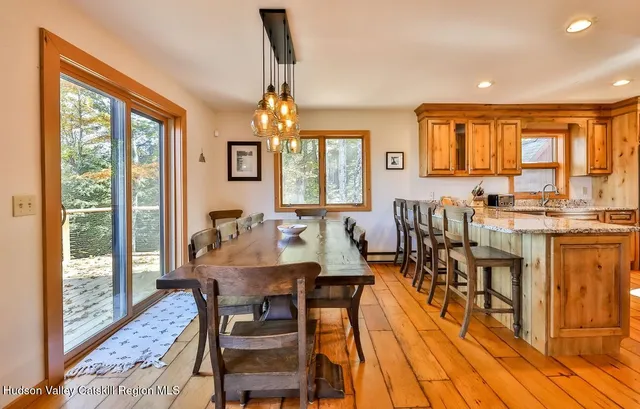 a view of a dining room with furniture window and wooden floor