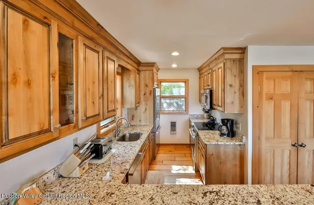 a kitchen with a sink stove top oven and cabinets