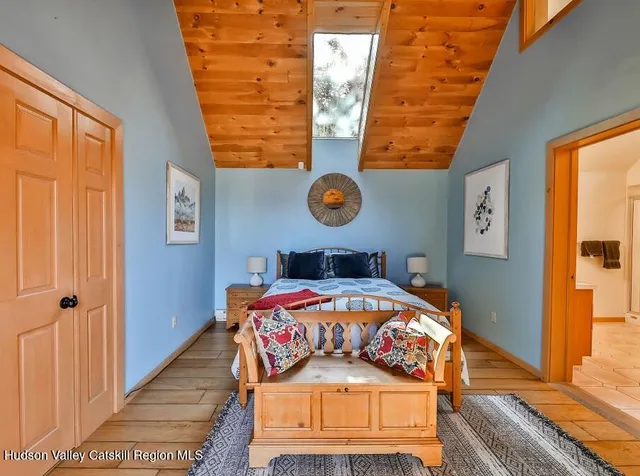 a bed sitting in a bedroom next to a window