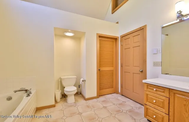 a view of staircase with white walls and a rug