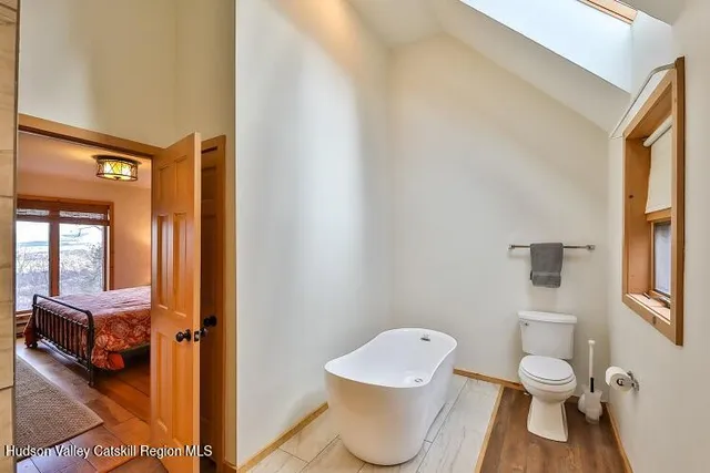 a bathroom with a granite countertop sink a toilet and shower