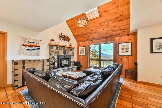a living room with furniture flat screen tv and a fireplace