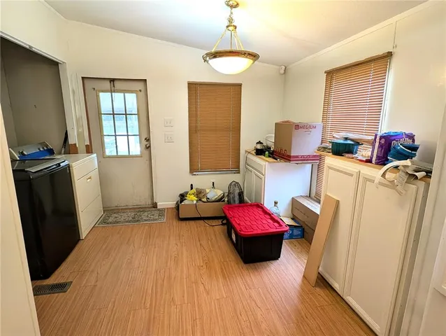 a kitchen with white cabinets and white appliances