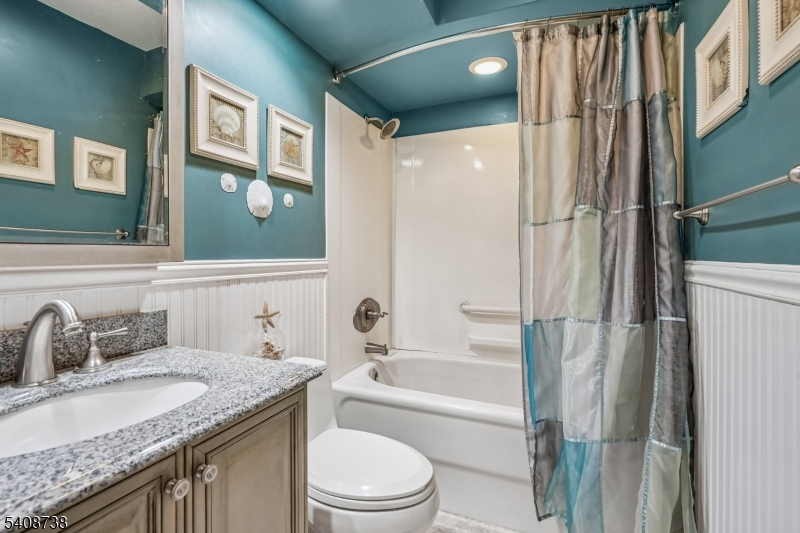 27 Espy Road, Unit A7 Caldwell, NJ 07006 - Photo 20 of 29 a bathroom with a granite countertop sink toilet and shower