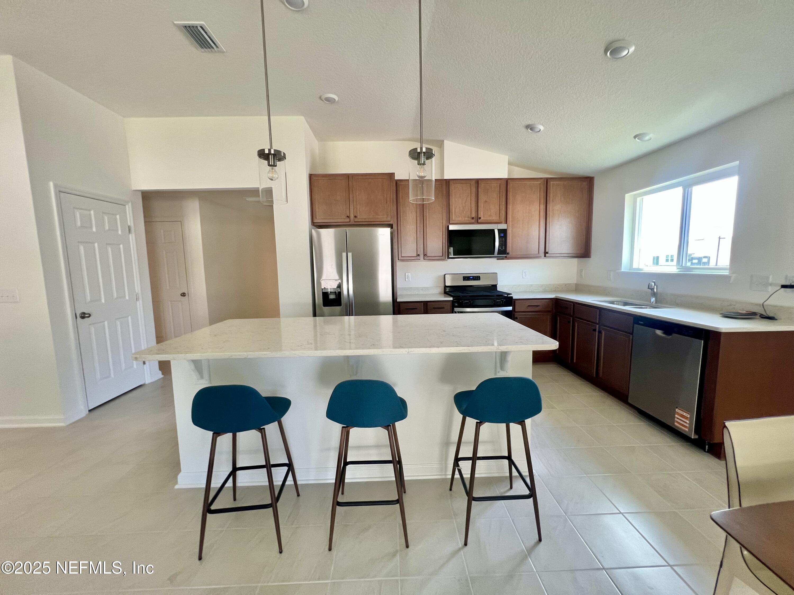 7714 Rippa Vly Way Jacksonville, FL 32222 - Photo 2 of 14 a kitchen with stainless steel appliances granite countertop a sink and a refrigerator