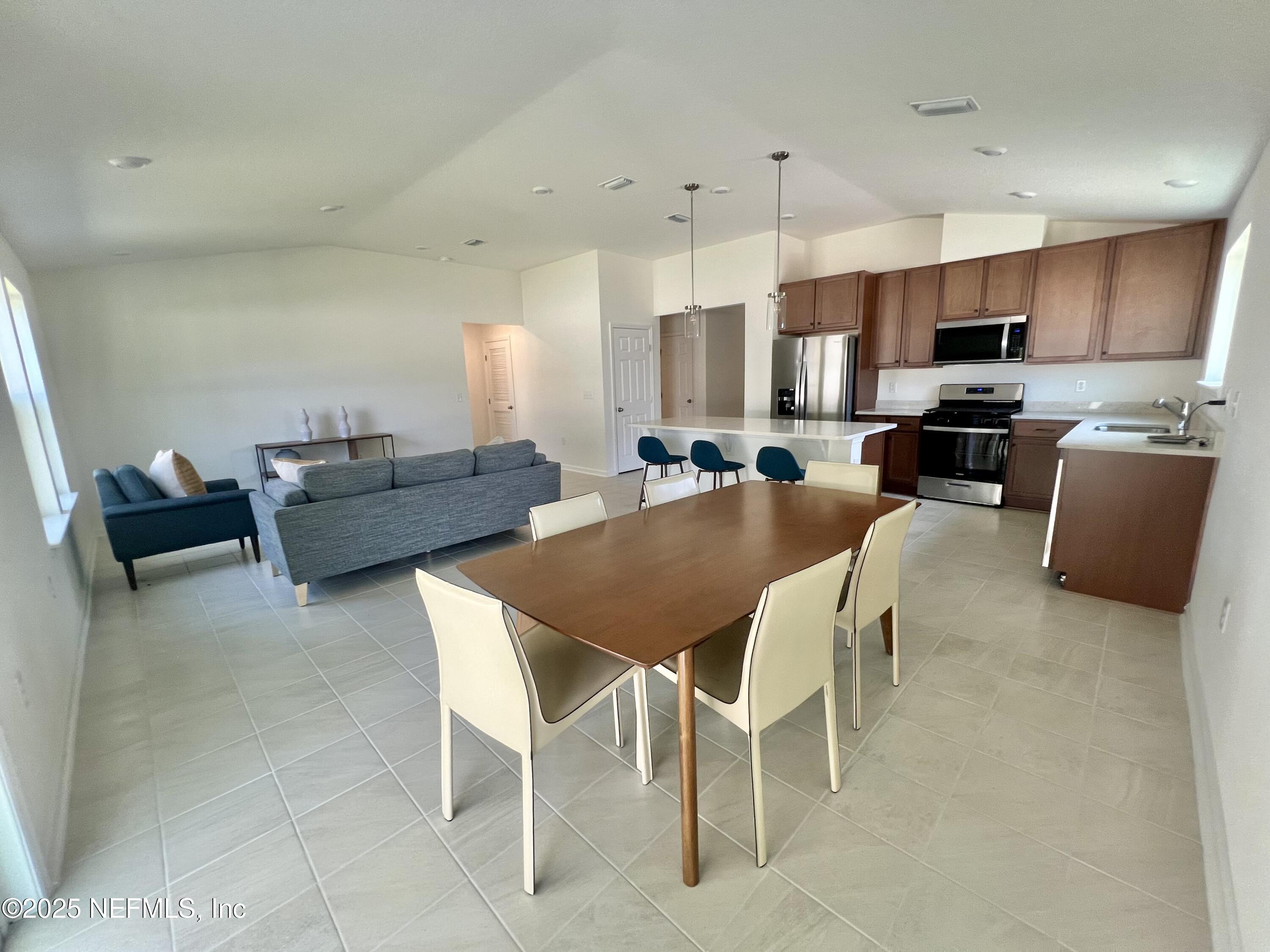 7714 Rippa Vly Way Jacksonville, FL 32222 - Photo 3 of 14 a view of a dining room with furniture