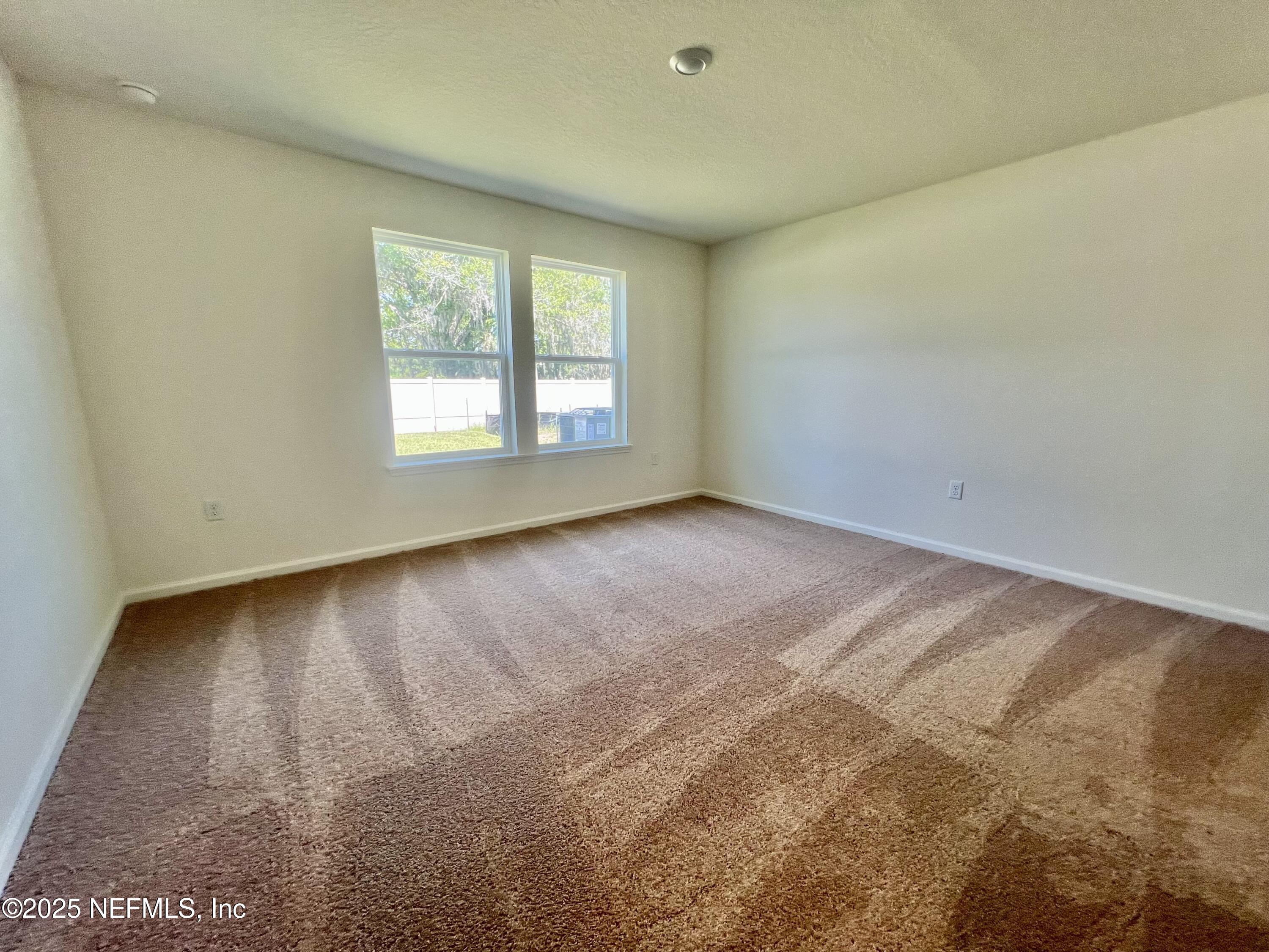 7714 Rippa Vly Way Jacksonville, FL 32222 - Photo 4 of 14 a view of an empty room with a window