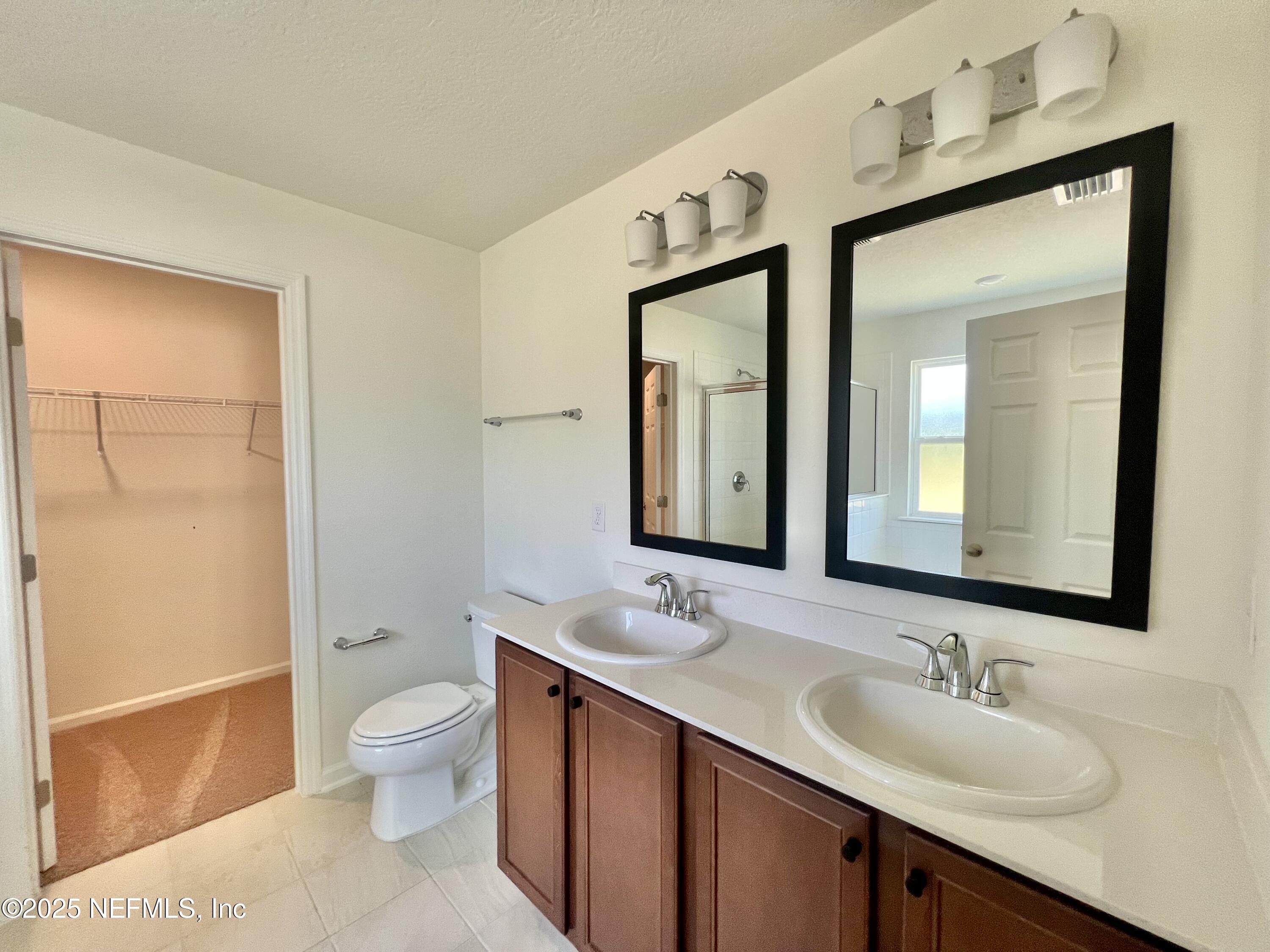 7714 Rippa Vly Way Jacksonville, FL 32222 - Photo 5 of 14 a bathroom with a toilet sink and mirror