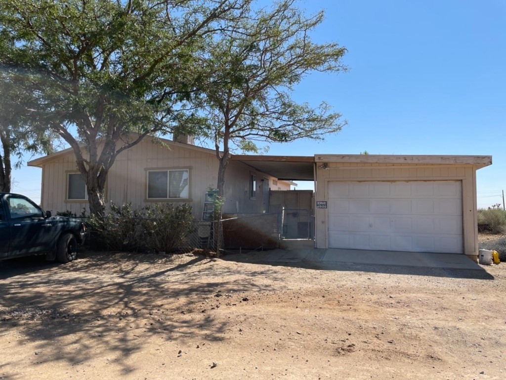 11101 Primrose Road Adelanto, CA 92301 - Photo 1 of 1 a front view of a house with a yard