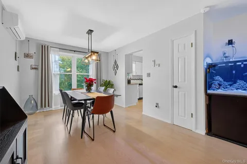 a dining room with furniture window and wooden floor