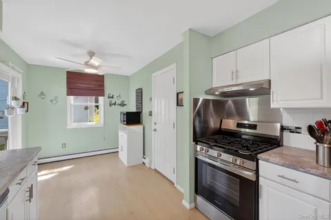 a kitchen with stainless steel appliances granite countertop a stove and a refrigerator