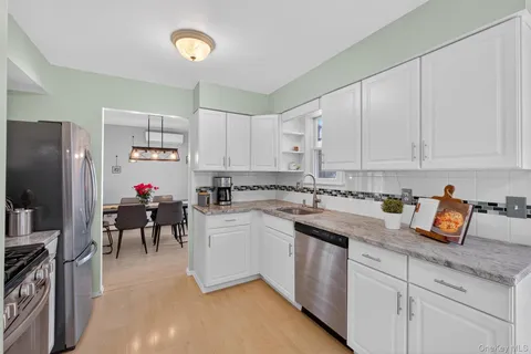 a kitchen with cabinets appliances and a counter space