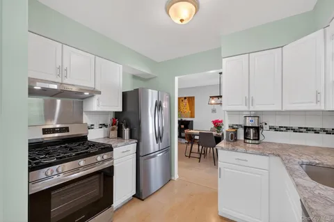 a kitchen with refrigerator a stove a sink and a counter top space