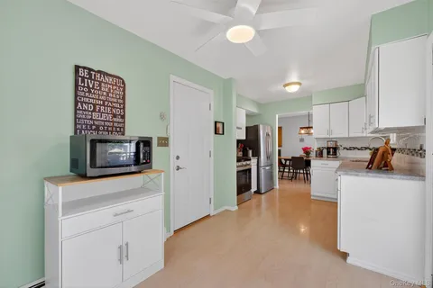 a kitchen with refrigerator and cabinets