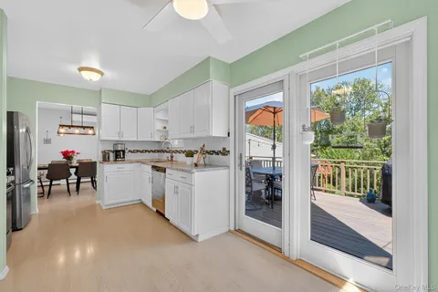 a kitchen with white cabinets and white appliances