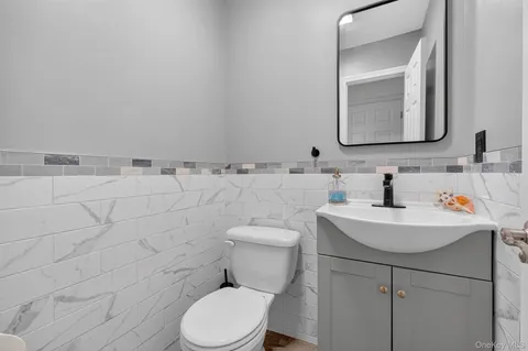 a bathroom with a toilet sink and mirror