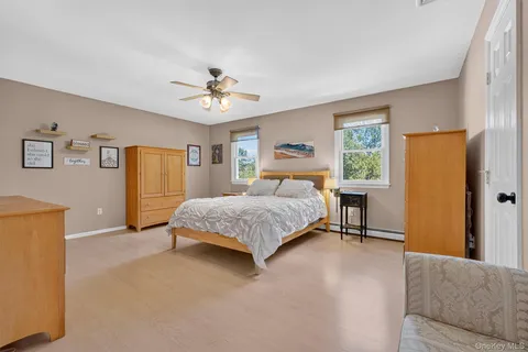 a bedroom with a bed dresser and a window