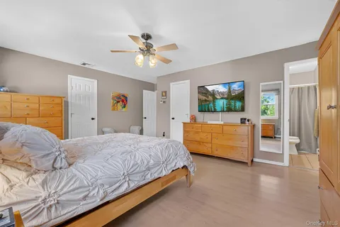 a bedroom with a large bed and a chandelier
