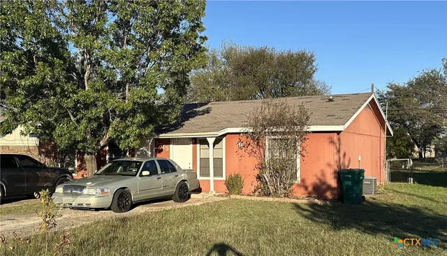 a view of a car parked in front of a house