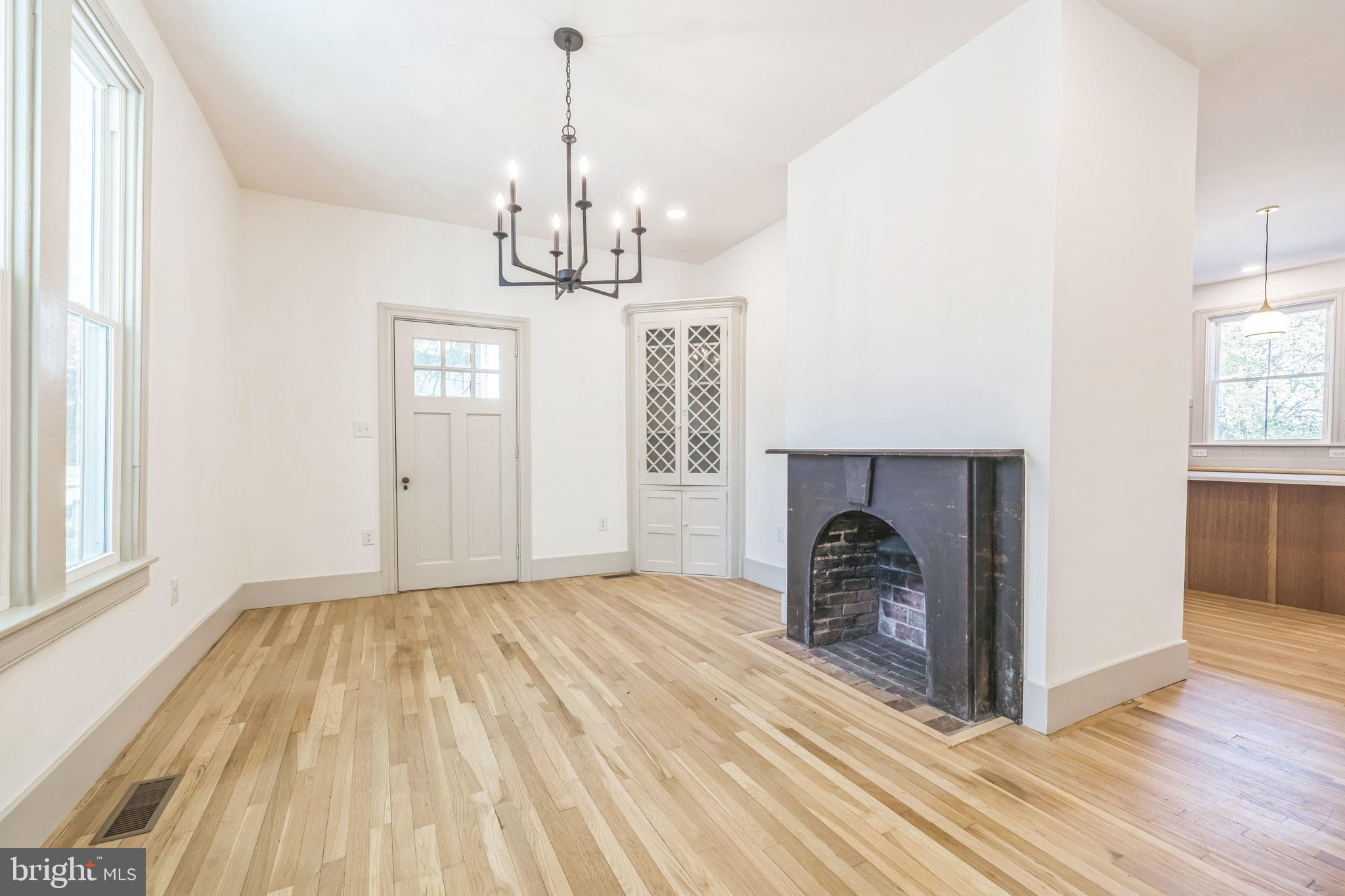 3860 Main Street Trappe, MD 21673 - Photo 11 of 58 a view of a livingroom with a chandelier and wooden floor