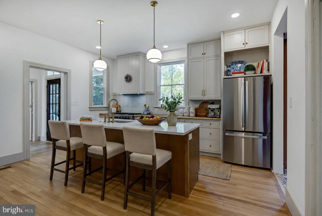3860 Main Street Trappe, MD 21673 - Photo 14 of 58 a kitchen with refrigerator a sink and chairs